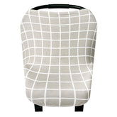 Copper Pearl 5-in-1 car-seat cover in use as a shield for parents on the go.