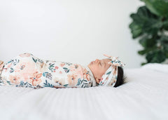 Copper Pearl coordinated-look bow beside swaddles creates cohesive baby styling.