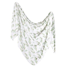 Copper Pearl Fern swaddle blanket flatlay shows soft knit fabric for cozy swaddling.