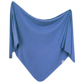 Copper Pearl Indigo swaddle blanket 46in on bed showing size and cozy warmth