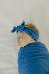 Copper Pearl Indigo swaddle demonstrates multifunctional use as nursing cover and wrap