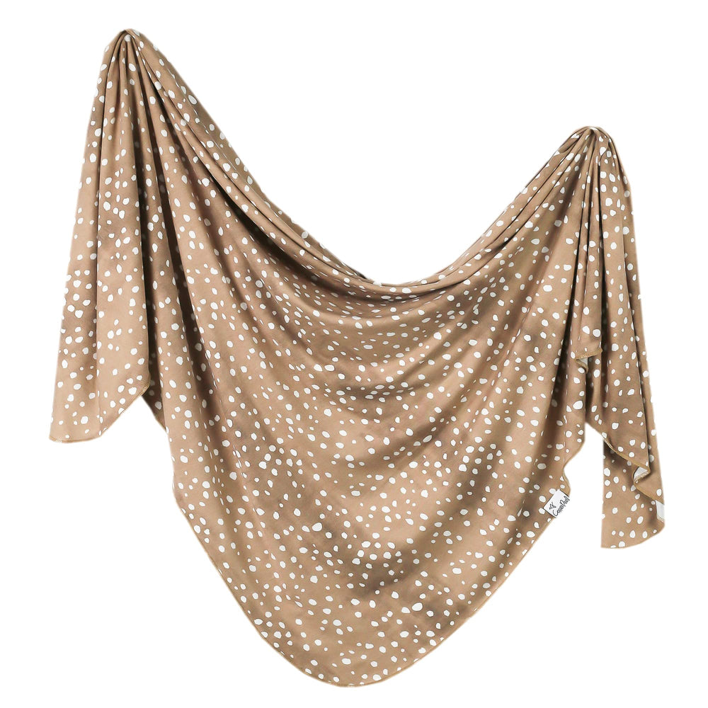 Copper Pearl large premium knit swaddle fawn folded shows soft, cozy fabric for newborn comfort.