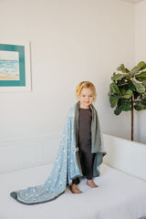 Copper Pearl Neil three-layer blanket with newborn snuggle use during naps.