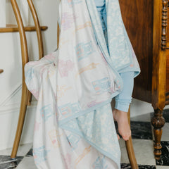 Copper Pearl Princess Palaces baby swaddle in bed; breathable warmth for cozy naps