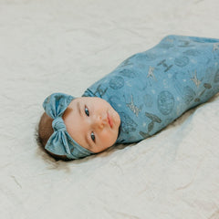 Copper Pearl Starships baby swaddled in blanket for cozy, secure bedtime transition