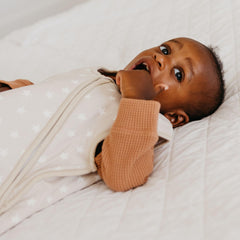 Copper Pearl Twinkle sleep bag front view highlighting snug fit in stylish nursery decor.
