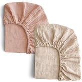 COSMOPLUS Muslin Crib Sheets two-pack layout in pale khaki and coral for nursery styling.