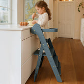 COSYLAND Foldi slate-blue front view demonstrates a sturdy toddler stool for independent kitchen tasks