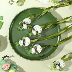 Coume baby shower favors table display β cohesive sage-green decor for the event.
