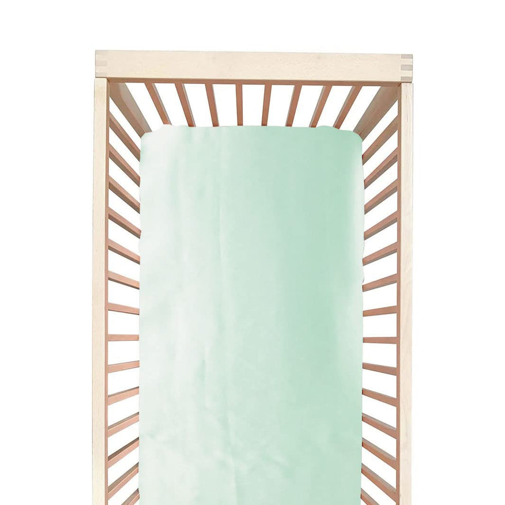 Cozysilk crib sheet in aqua green with silky softness for baby's sensitive skin.