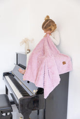 Cuddle Cookie Baby pink folded blanket offers cozy warmth for crib and stroller