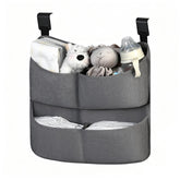 Cutebeams diaper caddy hanging on crib with four pockets for quick access
