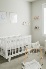 CutieCozy satin crib sheet close-up emphasizing durable, machine-washable fabric.