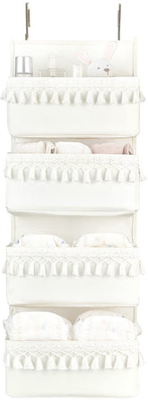 Dahey over the door organizer with white tassels keeps nursery clutter neatly organized.
