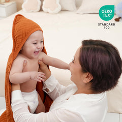David's Kids hooded baby towel brown 32x32 on baby shows fast absorbency after bath.