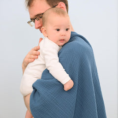 David's Kids Prussian Blue muslin blanket on stroller for shade and cover.