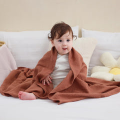 DaysU muslin swaddle baby wearing closeup highlights soft cotton texture against delicate skin.