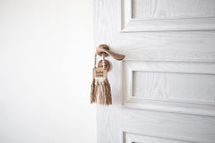 Decocove Babe Cave Sign tassels closeup shows tactile baby-friendly decor.