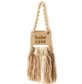 Decocove Babe Cave Sign wood bead garland adds cozy nursery style.