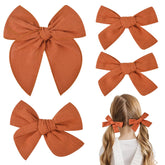 DEEKA burnt orange cotton-linen bow close-up shows soft fabric and gentle skin feel