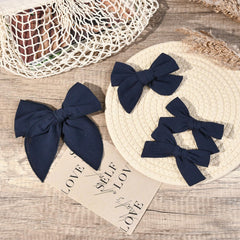 DEEKA navy blue 4-inch knot bow with clip, ideal for small ponytails and buns