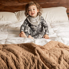 Denver James bandana bib with 2-button snap; adjustable fit grows with baby.