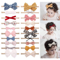 Doboi soft nylon headbands with secure bows for newborn comfort and fit.