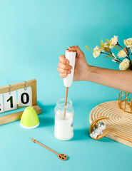 DOOBAANN handheld stirrer blending baby formula in bottle smoothly.