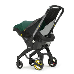 Doona Sunshade Extension fitted to car seat provides UV protection during travel.