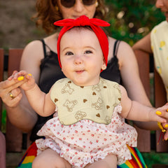 DOSMINE Muslin Baby Bibs with neutral patterns on a baby outfit