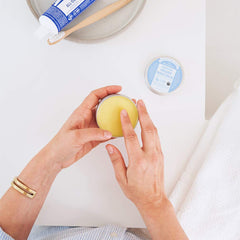 Dr. Bronner's Organic Magic Balm packaging and ingredients highlight organic beeswax and hemp oil benefits