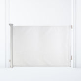 Dreambaby Glide N Hide 55-inch gate extended, securing wide stairways and hallways for safe open-plan spaces.