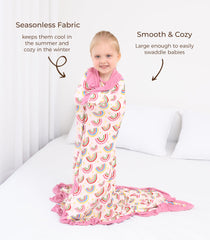 DREAMHALO crib bedding in nursery with rainbow-ruffle blanket accent.