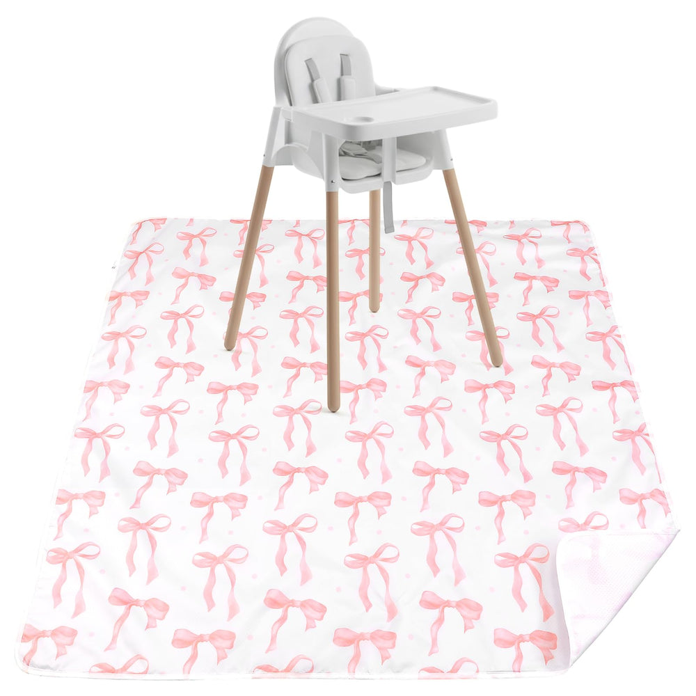 Drydiet Baby Splat Mat pink bow under high chair protects floors from spills.