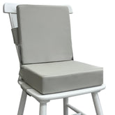 Eiury booster seat on a dining table in light grey, showing sturdy seating at mealtime