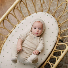 Ely's & Co bassinet sheets on hourglass mattress showing breathable, wrinkle-free design