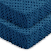 Entisn baby crib sheets two-pack in navy blue folded for a snug fit on standard mattresses.