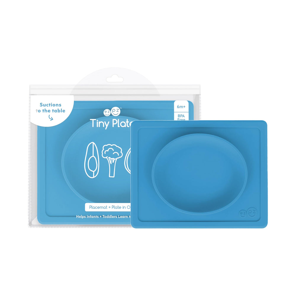 ezpz Tiny Plate blue on a highchair tray showing secure suction for self-feeding