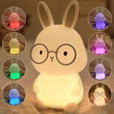 Famiduo bunny night light glowing softly on a kid's bedside table for bedtime comfort.