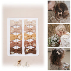 Fancy Clouds daisy display-card hair clips show secure wrap and color variety.