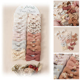 Fancy Clouds baby hair ties with 2in linen bows closeup highlights soft texture and gentle hold