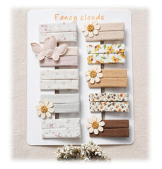 Fancy Clouds flower butterfly hair clip close-up showing gentle fabric finish for fine hair.