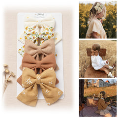 Fancy Clouds hair bows display five flower-embroidered styles for bright outfits.