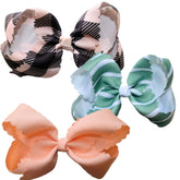 Fifi & Ry premium bow in green stripes showing secure five-inch fit for active toddlers