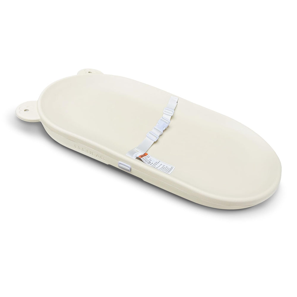 FLEUFAB baby changing pad on dresser with adjustable strap for safe, hands-free diaper changes