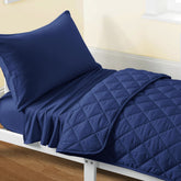 FLXXIE toddler bedding navy blue quilt closeup highlighting soft microfiber comfort for quiet nights.