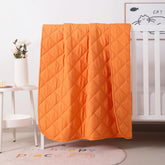 FLXXIE toddler comforter orange folded—travel-friendly warmth