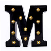 Foaky black LED marquee number lights sign mounted on wall with warm glow