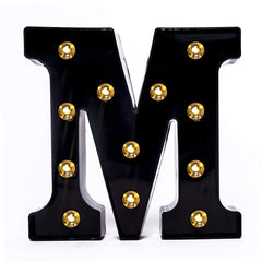 Foaky black LED marquee number lights sign mounted on wall with warm glow