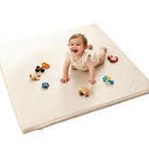 FONESO Baby Play Mat beige closeup shows soft vegan leather for gentle play surface.